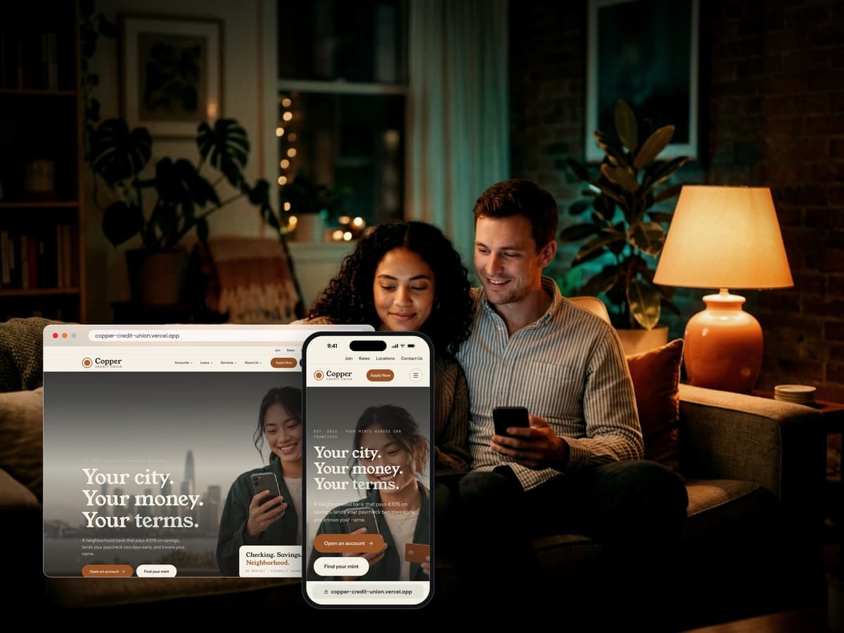Couple at home browsing a credit union website on a laptop and phone